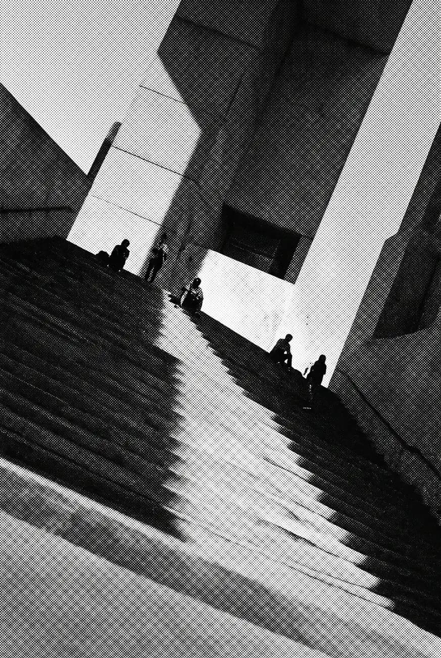 Stairs and volumes of a modern building, in high-contrast black and white