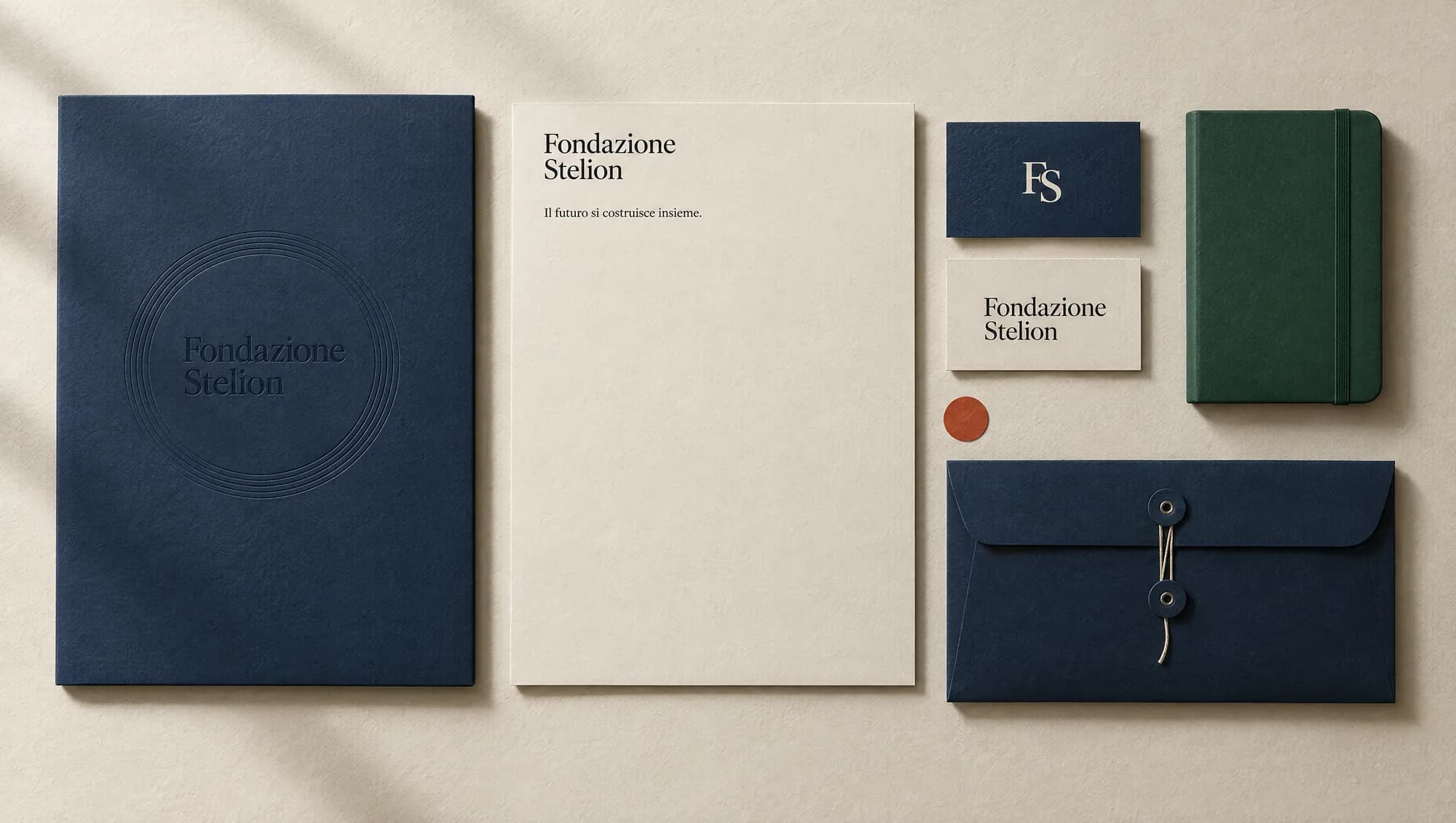 Fondazione Stelion navy folder, letterhead, business cards and envelope on warm paper