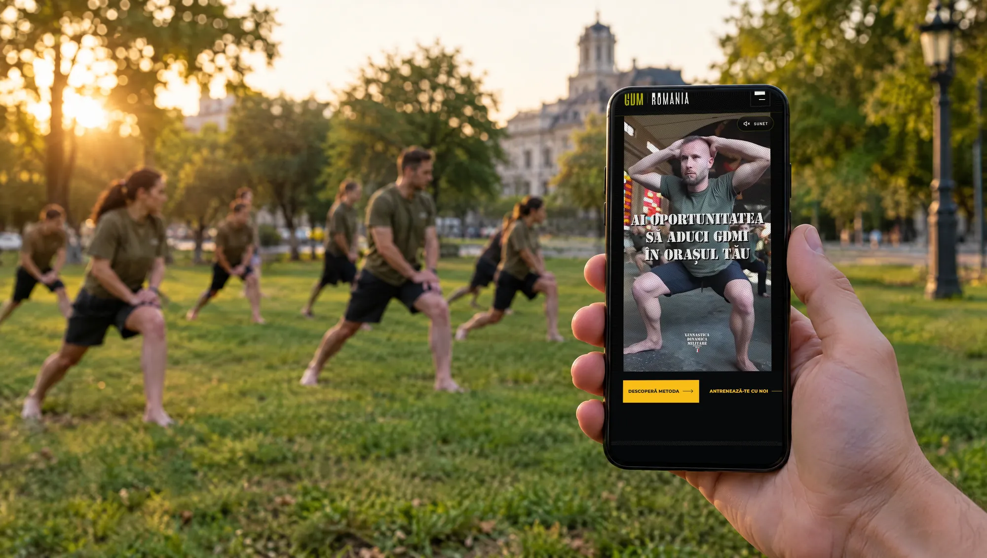 The GDM România website on a phone, in front of a group training in a park